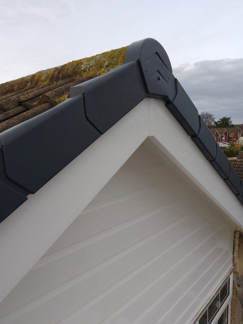 White soffit with a dark dry verge on a gable end