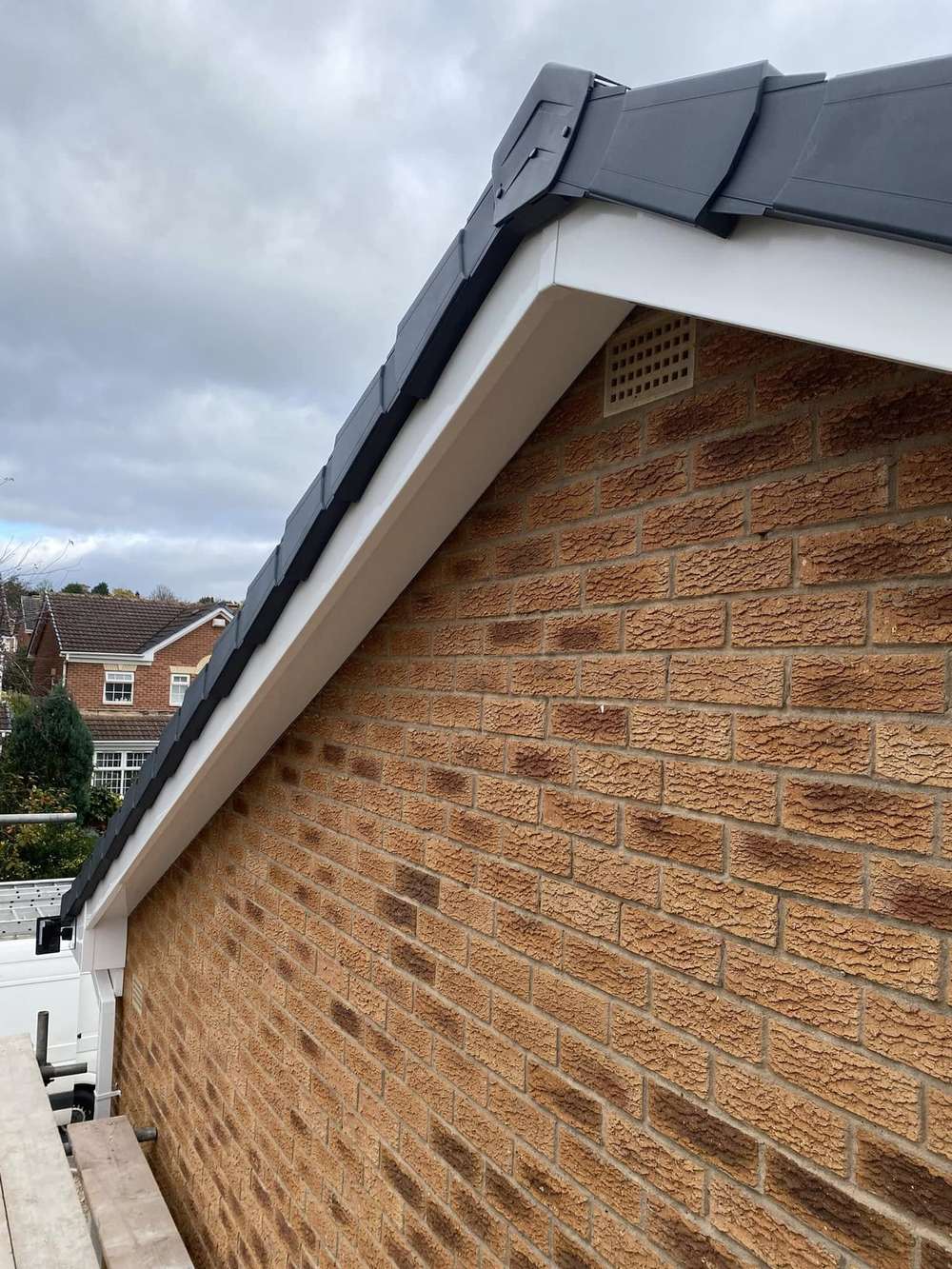 Brick gable with new white soffit and an anthracite dry verge