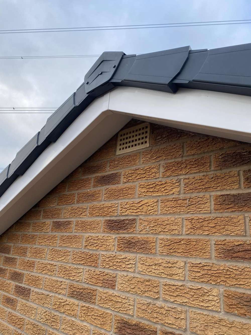 The same gable finished with white soffit and anthracite dry verge