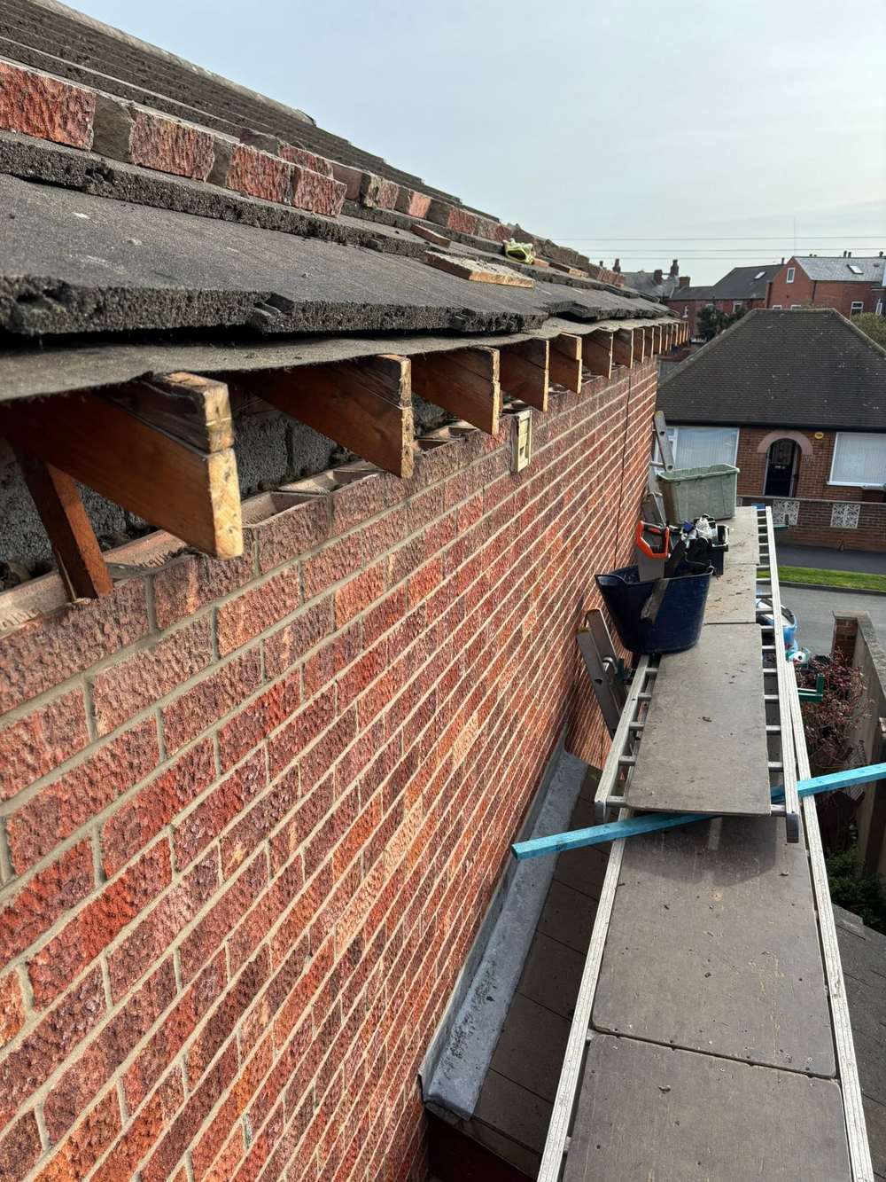 Rafter ends exposed along the eaves of a red brick house