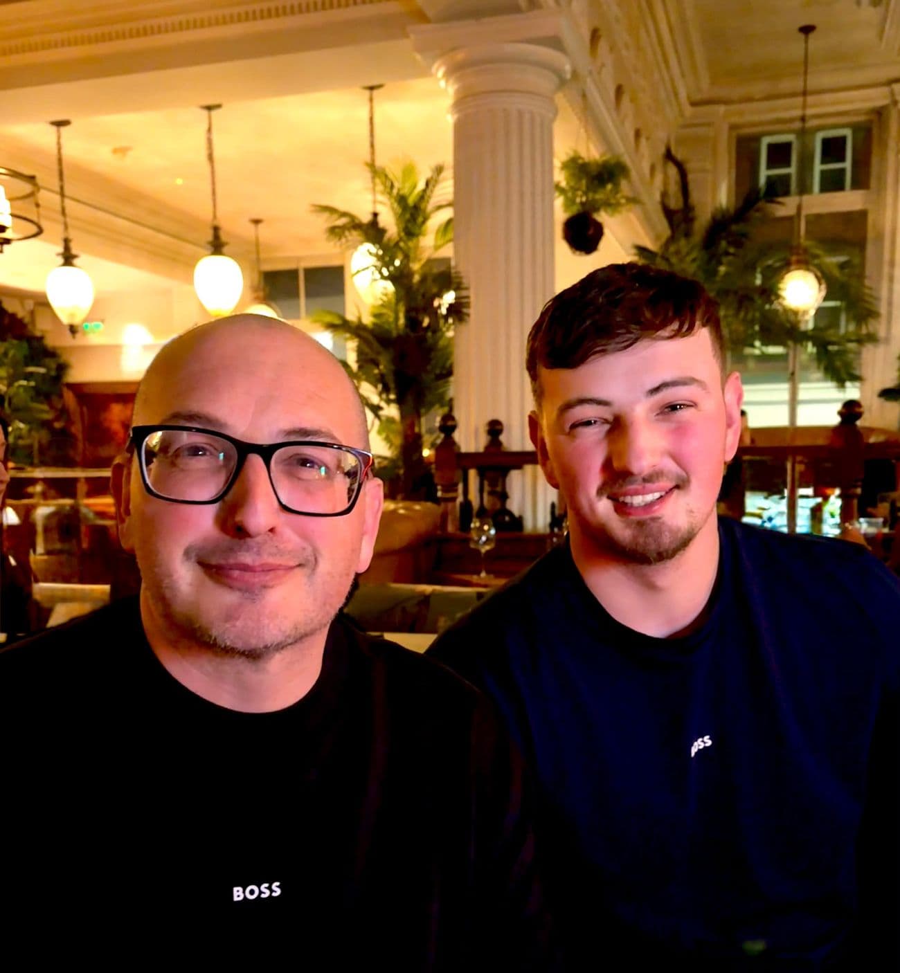 Richard Fletcher and his son Elliot, smiling, sitting side by side