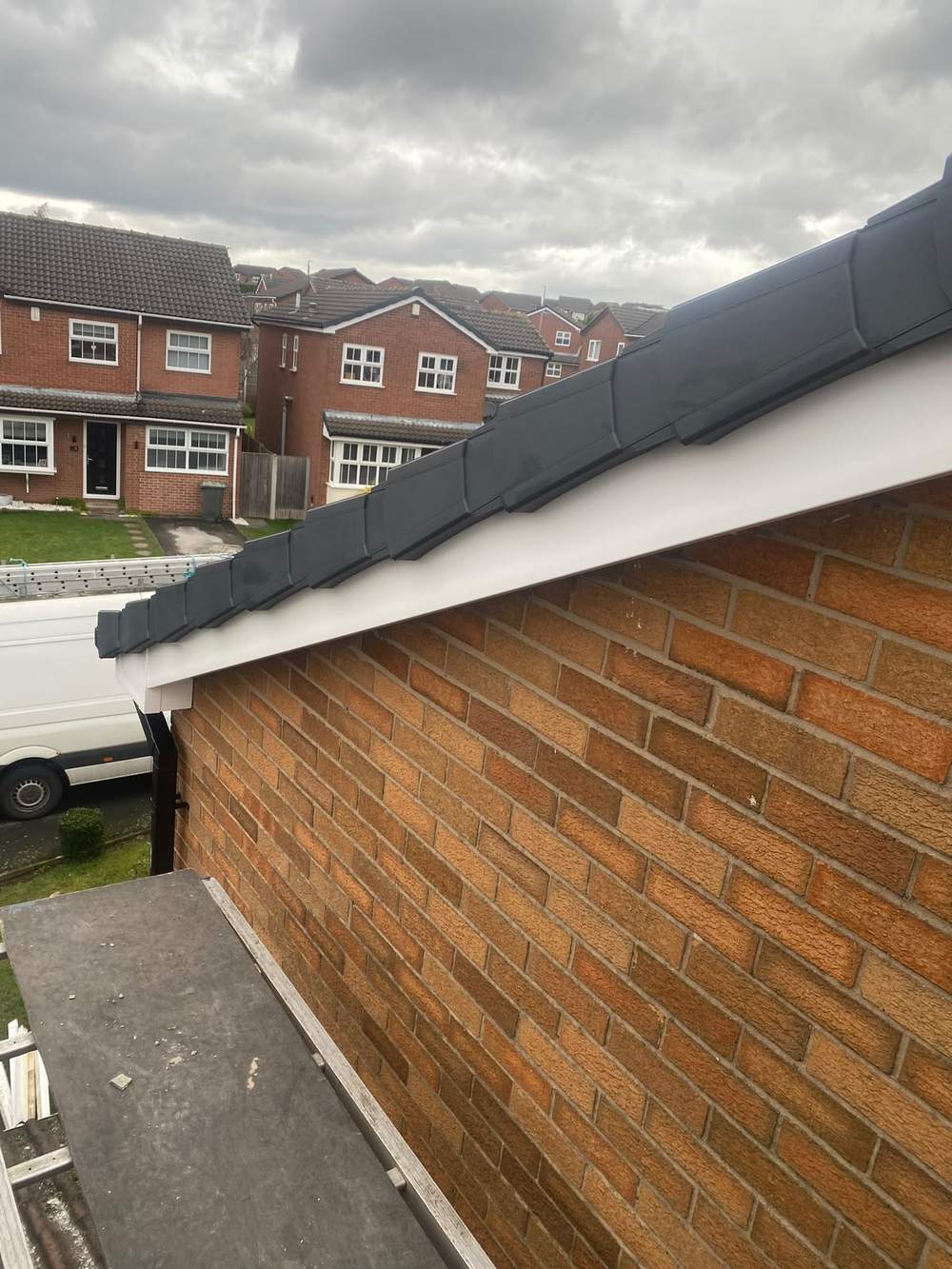 The same gable with new white fascia and anthracite dry verge