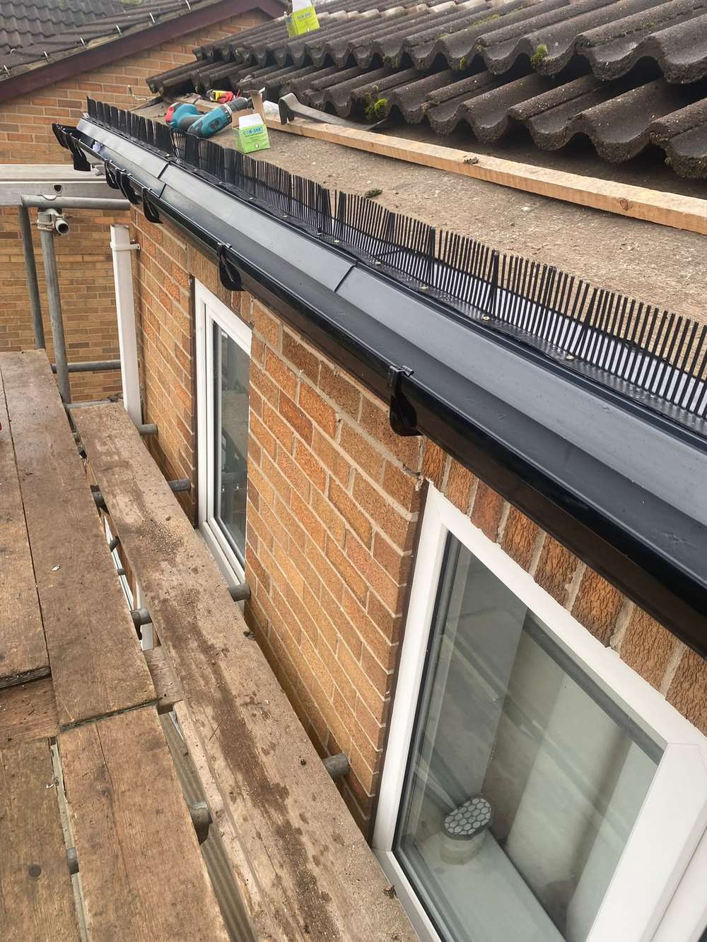 New black gutter and bird comb being fitted along the new fascia