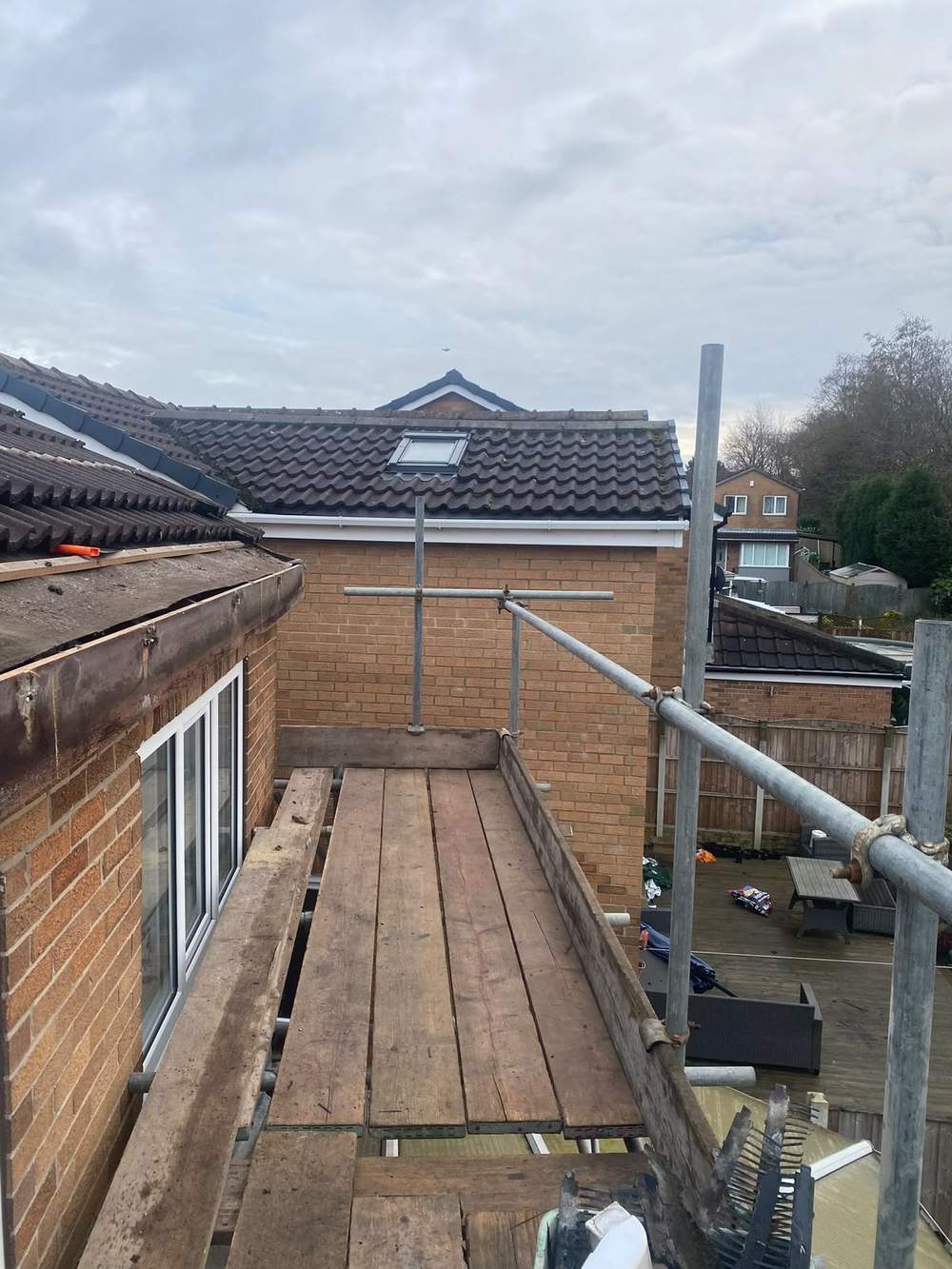Scaffold platform along the back of a house, level with the roofline