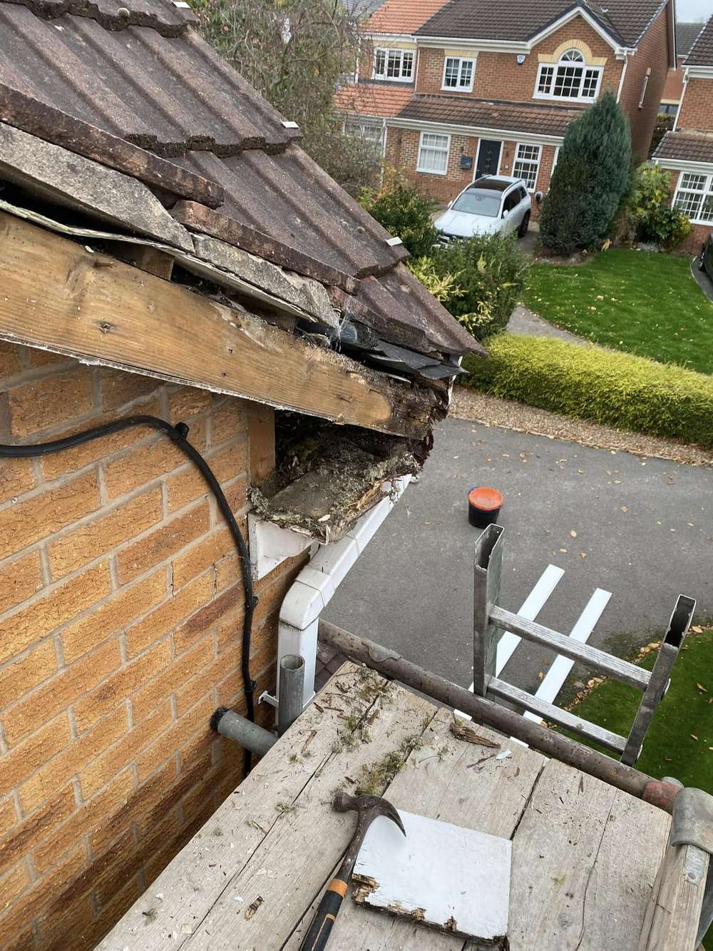 A collapsed eaves corner with rotten timber, seen from the staging